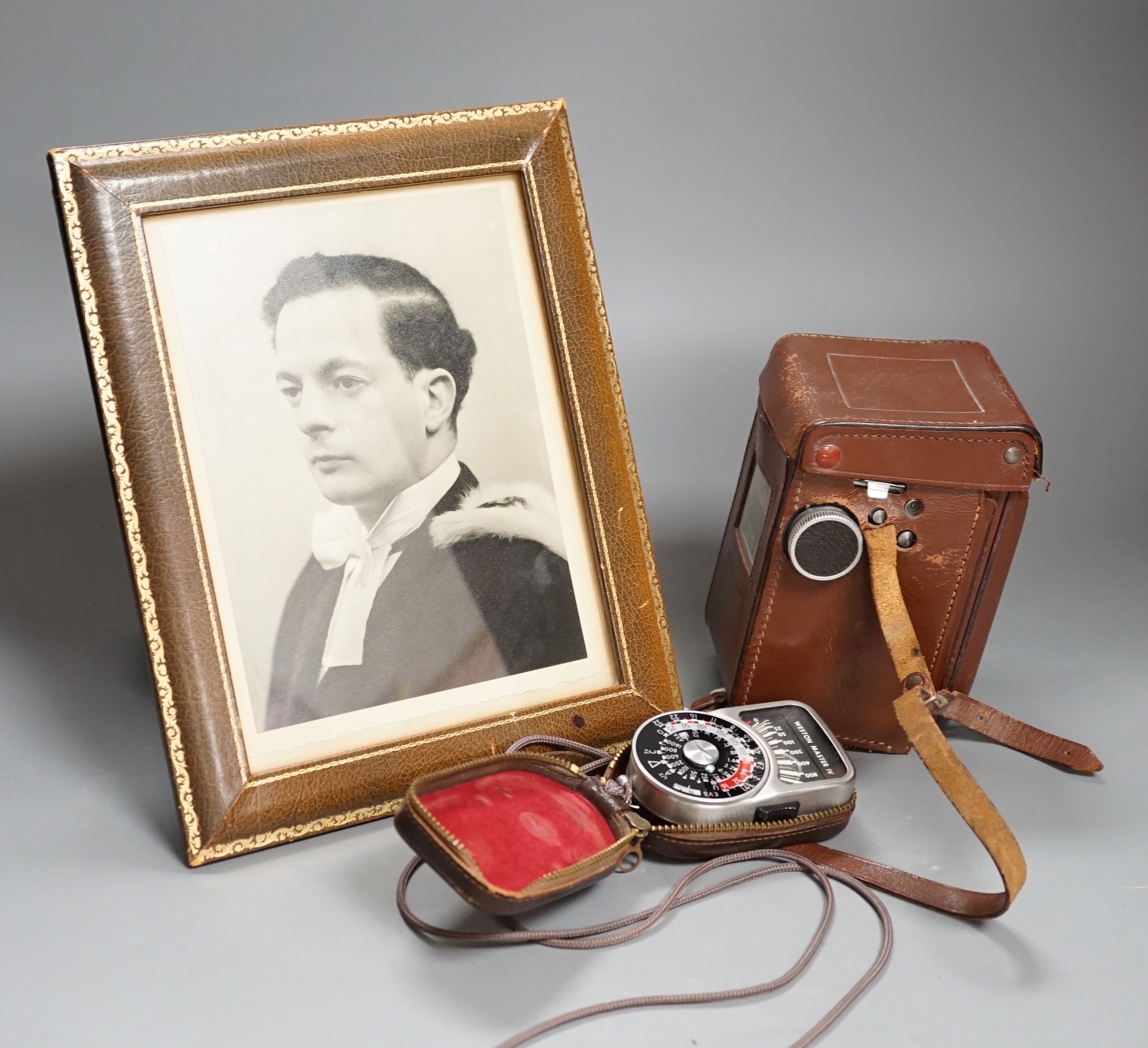 A Rolleicord TLR camera model Va, serial no. 1942058, with a Weston Master IV universal exposure meter and a Harrod's leather photo frame